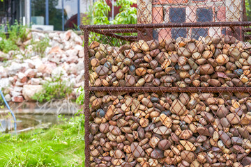 Close-up of reinforced pillars decorated with pebbles in the garden