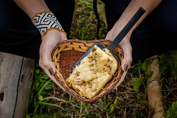 Sao Paulo, SP, Brazil - May 5 2022: Woman holding basket with piece of vegetable pie details