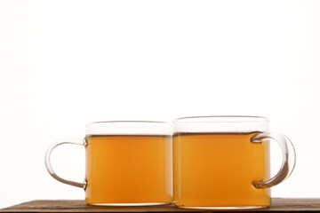 Crystalline golden tea cups on a white background  