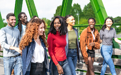 Big group of friends walking in the campus while laughing and having fun - Portrait of teens guys and girls enjoying day