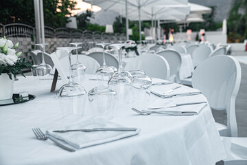 Round table in a restaurant on a summer terrace under the open sky at sunrise