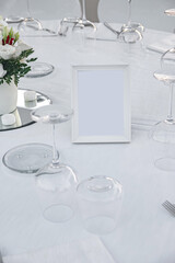 Set table with white tablecloth in restaurant.