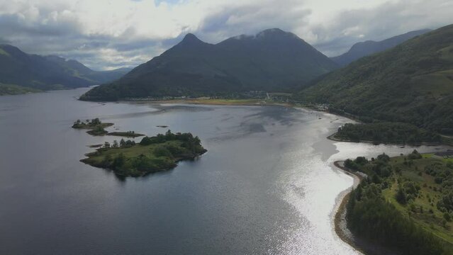 Aerial flyover view of Loch Leven and Glencoe with Ben Nevis mountain in the background	