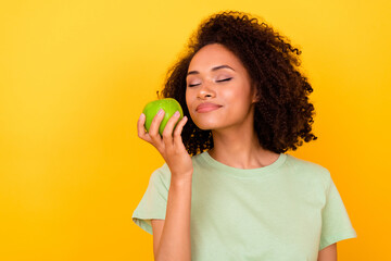 Photo of dreamy sweet girl dressed green t-shirt enjoying fresh apple aroma empty space isolated...