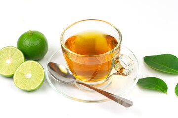 Hot tea in glass cup with fresh lime and green leaf isolated on white background.