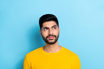 Fototapeta premium Photo of serious confident guy dressed yellow pullover looking empty space isolated blue color background