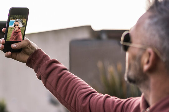 Smartphone view of the screen with a handsome man's selfie