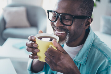 Close up photo of aged man agent feel positive have coffee break smell aromatic latte in modern workstation