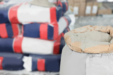 Cement powder in bag indoors, closeup. Space for text
