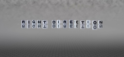 right direction word or concept represented by black and white letter cubes on a grey horizon background stretching to infinity