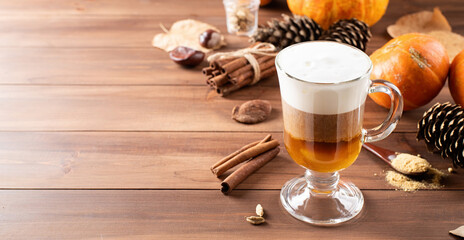 Pumpkin spice latte in a glass mug with cinnamon and ginger
