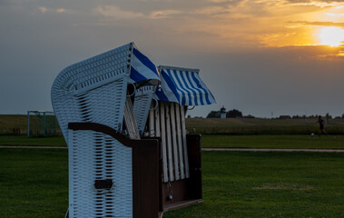 Beach chairs during sunset in Altenbruch near Cuxhaven, Germany.