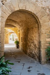 Monells, a beautiful medieval village in the Baix Empordà. Gerona. Spain. Arch in the narrow streets of the village