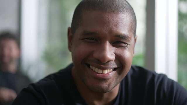Happy African American man portrait closeup face. A black person smiling at camera. A Brazilian guy