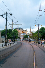 View of Santa Sofia from the street, with the empty tram tracks, in the evening light.