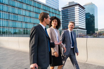 Business people meeting in a business park - International multiethnic business team walking on the street in the city
