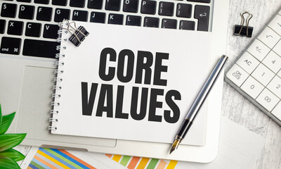 Core Values text and notepad with pen, charts and calculator
