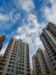 Fototapeta na wymiar Cloudy blue sky in the gap of high raise building