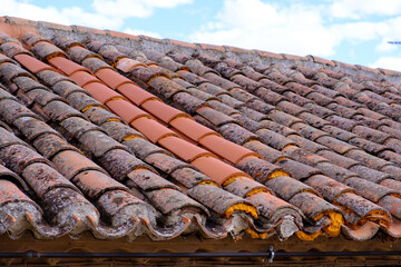 repair of old roof with new tiles and insulation foam
