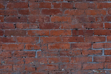 Rustic red brick wall close up.