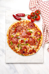 homemade pepperoni pizza with salami and vegetables