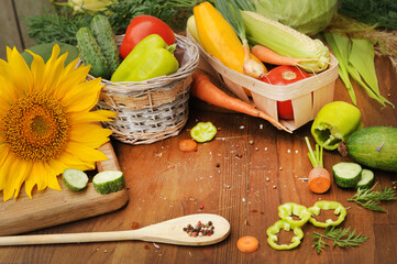 Wooden background with assorted raw vegetables