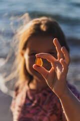 A little girl holding amber
