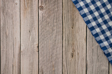 Background wood table with blue checkered tablecloth