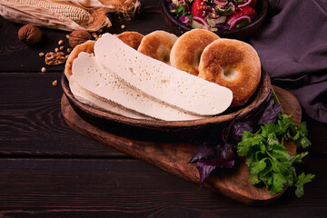 Mchadi, corn tortillas, traditional Georgian dish, corn bread, with Imeretian cheese, homemade, no people, on a wooden table,