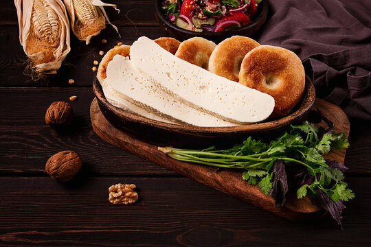 Mchadi, corn tortillas, traditional Georgian dish, corn bread, with Imeretian cheese, homemade, no people, on a wooden table,