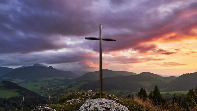 Christian cross in mountain nature. Beautiful colorful clouds at sunset. 