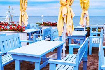 Empty beach cafe without visitors. Embankment on a cloudy day.