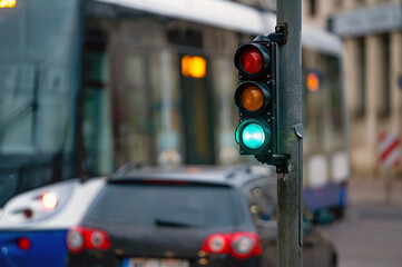 traffic light on the street junction with beautiful bokeh, city with cars in the background