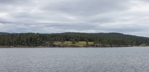 Islands surrounded by ocean and mountains. Summer Season. Gulf Islands near Vancouver Island, British Columbia, Canada. Canadian Landscape.