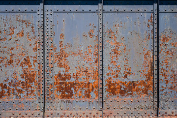 Rusty metal background - Old rundown grey and blue peeling paint reveal patterns on a rusted metal surface.