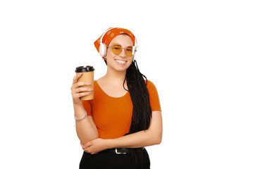 Smiling girl with braids is holding her cup of coffee  while she is smiling at the cmera