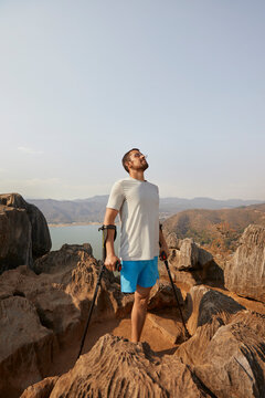 Disabled man standing on rock with crutches