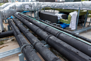 Pipe of air conditioner system on roof. a lot of pipe for air conditioner system. Industrial air conditioning tubes. Ventilation system and pipe systems installed on industrial building.
