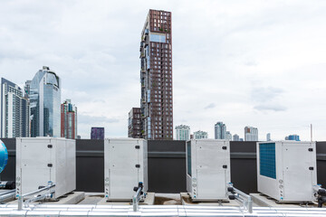 Air conditioner compressor installed on roof building.  Industrial air conditioning units. Industrial air conditioning and ventilation systems on roof. Cooling towers in data center building. 