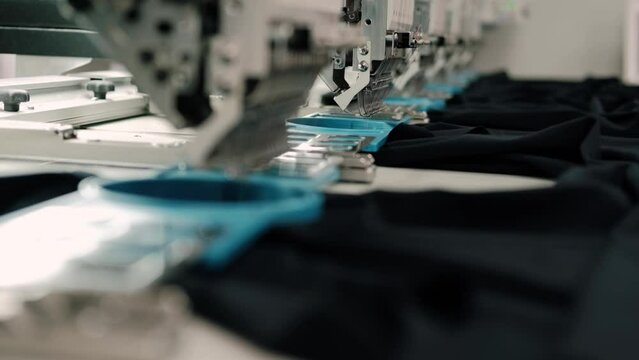 The automatic embroidery machine is working at high speed. Close-up. Computerized embroidery machines.