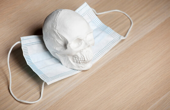 image of skull medical mask wooden desk background 