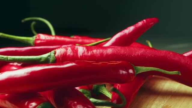 On wood plank Ripe red long hot chili peppers are the world's number one culinary delight and cash crop in New Mexico, USA, Vietnam, Thailand, Asia. They are a delightful part of world cuisine.