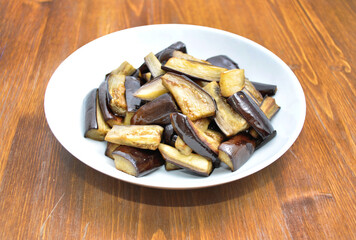 dish with baked eggplant on a wooden table