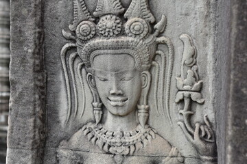 Fototapeta na wymiar Rare Smiling Woman with Teeth Relief Carving Closeup in Angkor Wat, Siem Reap, Cambodia
