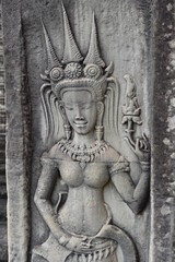 Fototapeta na wymiar Rare Smiling Woman with Teeth Relief Carving in Angkor Wat, Siem Reap, Cambodia
