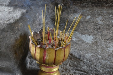 Fototapeta na wymiar Incense Offering at Buddhist Altar in Angkor Wat, Siem Reap, Cambodia