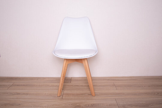 
Modern White Leather Chair On Wooden Background