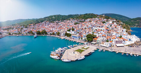 Panoramic aerial view of the beautiful town and harbour of Skopelos island with the traditiona, red roofed white houses, Sporades, Greece