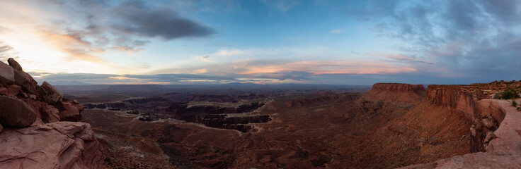 Fototapeta na wymiar Scenic Panoramic View of American Landscape and Red Rock Mountains in Desert Canyon. Cloudy Sunrise Sky. Canyonlands National Park. Utah, United States. Nature Background Panorama