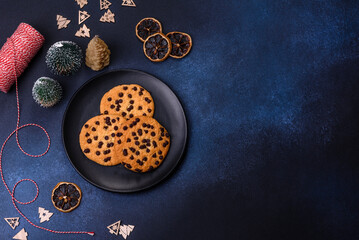 Christmas decorations and gingerbreads on a dark concrete table